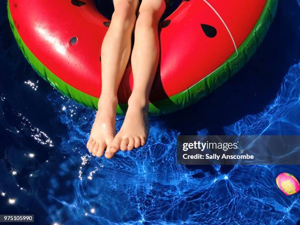 childs playing on an inflatable - sally anscombe stock-fotos und bilder