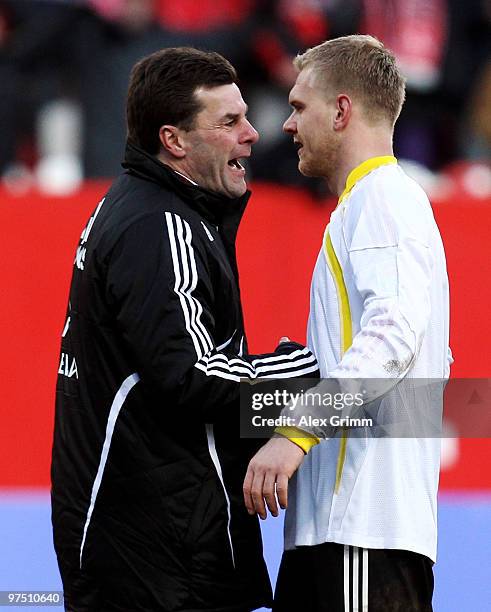 Head coach Dieter Hecking of Nuernberg celebrates with Andreas Wolf after the Bundesliga match between 1. FC Nuernberg and Bayer Leverkusen at Easy...