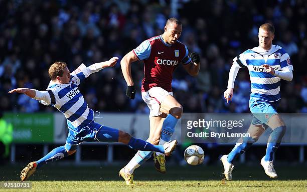 Ryan Bertrand of Reading tackles John Carew of Aston Villa during the E.ON sponsored FA Cup Quarter Final match between Reading and Aston Villa at...
