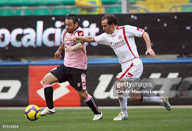 Fabrizio Miccoli of US Citta' di Palermo battles for the ball with Antonio Filippini of AS Livorno Calcio during the Serie A match between US Citta...