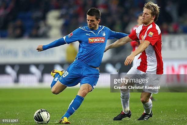 Eugen Polanski of Mainz tackles Vedad Ibisevic of Hoffenheim during the Bundesliga match between 1899 Hoffenheim and FSV Mainz at Rhein-Neckar Arena...