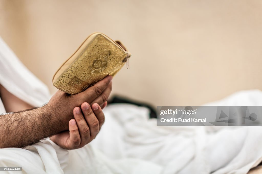 Mid adult man reading Koran, Mina, Saudi Arabia