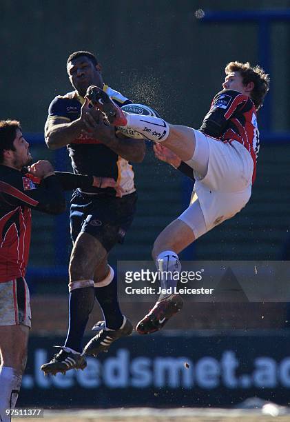 Alex Goode of Saracens and Seru Rabeni of Leeds Carnegie jump for the high ball during the Guinness Premiership match between Leeds Carnegie and...