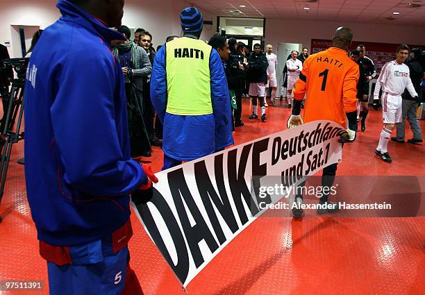 Players of team Haiti carries a banner prior the charity match for earthquake victims in Haiti between ran Allstart team and National team of Haiti...