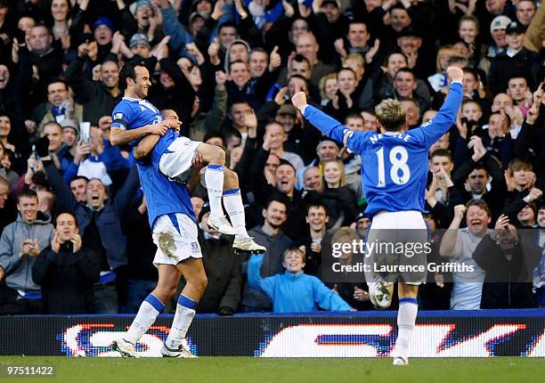 Landon Donovan of Everton is lifted in the air by Jack Rodwell after scoring the fourth goal during the Barclays Premier League match between Everton...