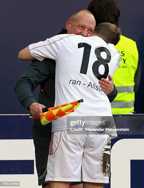 Oliver Pocher of the ran AllstarTeam celebrates with the Linesman during the charity match for earthquake victims in Haiti between ran Allstar team...