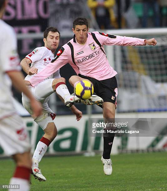 Igor Budan of US Citta' di Palermo battles for the ball with Romano Porticone of AS Livorno Calcio during the Serie A match between US Citta di...