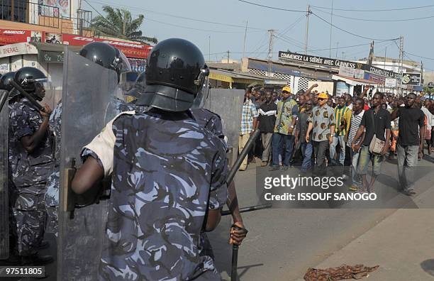 Togolese gendarmes and police forces walk towards hundreds of supporters of Jean-Pierre Fabre, leader of the Union of Forces of Change , the main...