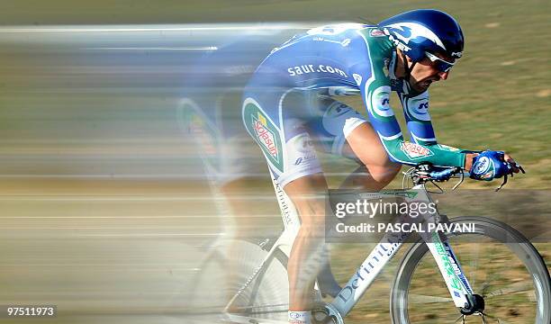 Picture taken with a speed filter effect shows France's Saur-Sojasun cycling team, France's Laurent Mangel, competes on March 7, 2010 around...