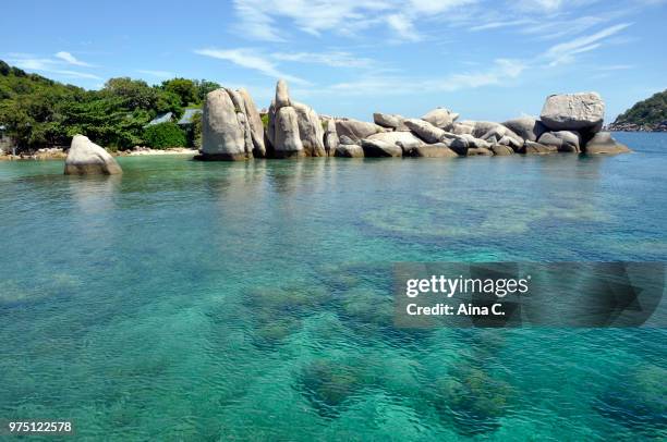 rocks in the sea - aina stock pictures, royalty-free photos & images