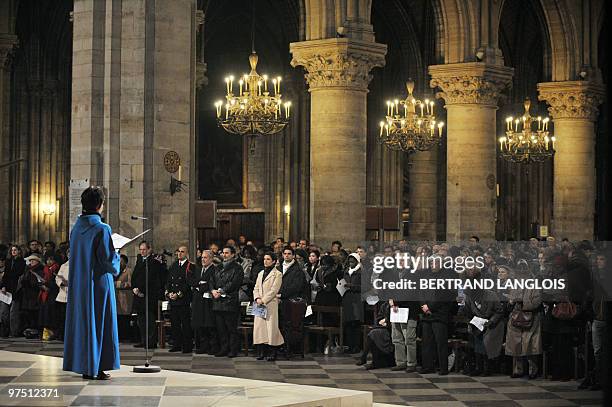 French deputy minister for Ecology Chantal Jouanno and other people attend a mass in memory of victims of the storm that tore into southwest France...