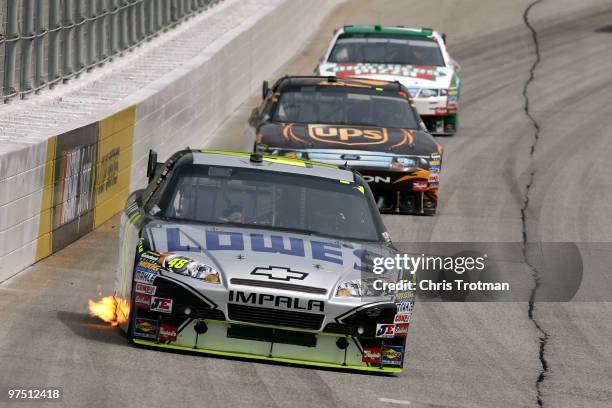 Jimmie Johnson, driver of the Lowe's/KOBALT Tools Chevrolet, leads David Ragan, driver of the UPS Ford, and Elliott Sadler, driver of the Hunt...