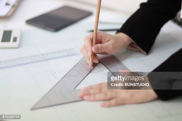architect drafting blueprint with ruler and pencil - plan architecte photos et images de collection