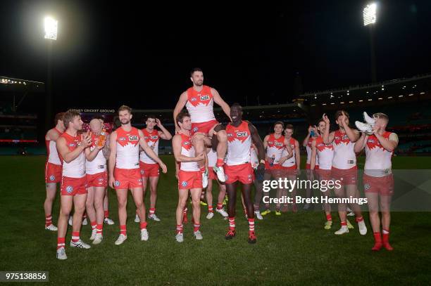 Heath Grundy of the Swans is carried from the fielf after victory during the round 13 AFL match between the Sydney Swans and the West Coast Eagles at...