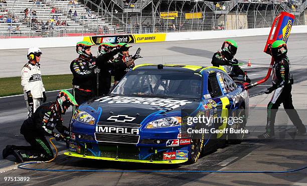 Mark martin, driver of the Hendrickcars.com Chevrolet, pits while the crew surveys damage to the car during the NASCAR Sprint Cup Series Kobalt Tools...