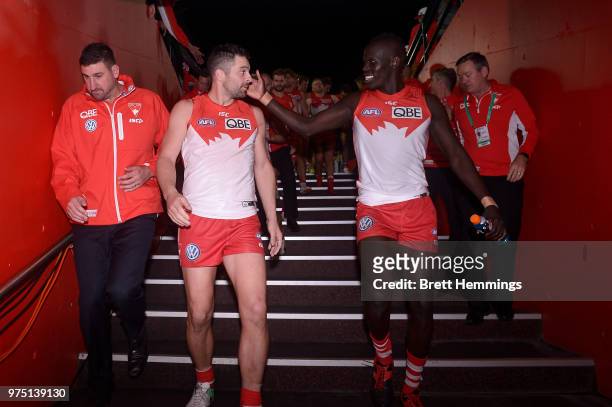 Heath Grundy of the Swans and Aliir Aliir of the Swans celebrate victory during the round 13 AFL match between the Sydney Swans and the West Coast...