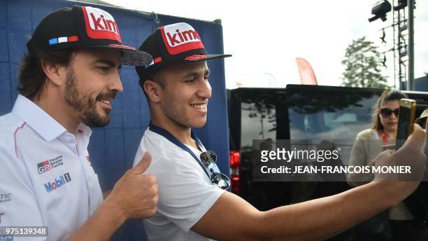 Toyota TS050 Hybrid LMP1 Spainish driver Fernando Alonso takes a selfies with a Spanish fan ahead of the 86th edition of the 24 Hour Race on June 15...