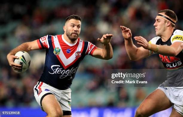 James Tedesco of the Roosters uns as the ball as Isaah Yeo of the Panthers looks to tackle during the round 15 NRL match between the Sydney Roosters...