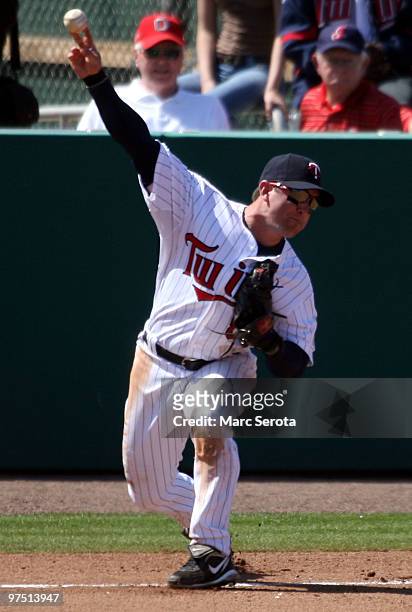 Third baseman Nick Punto of the Minnesota Twins throws to first base against the New York Yankees at Lee County Sports Complex on March 7, 2010 in...
