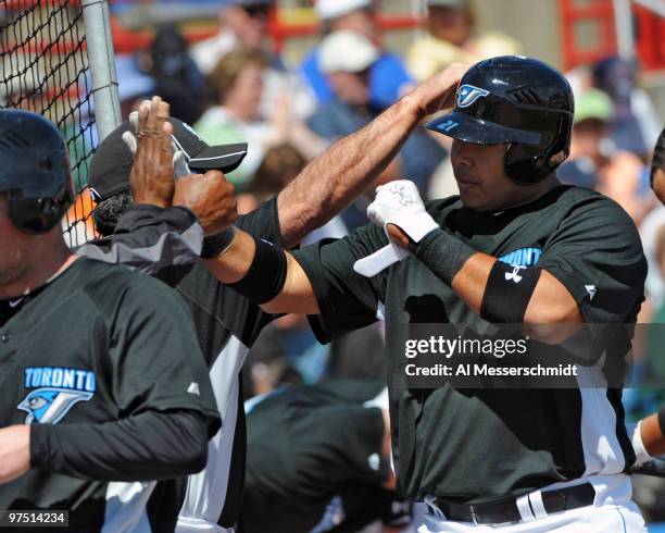 Infielder Randy Ruiz of the Toronto Blue Jays celebrates a grand slam home run against the Detroit Tigers March 7, 2010 at Dunedin Stadium in...