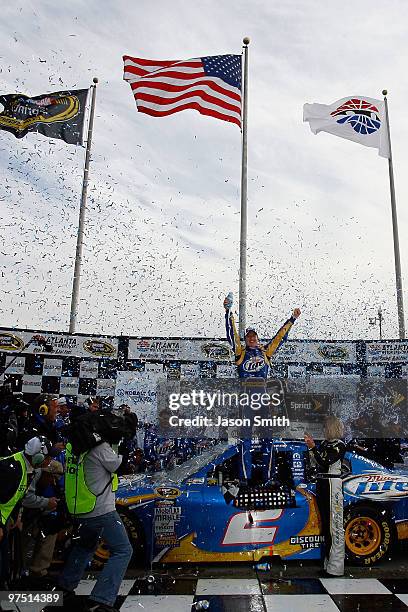 Kurt Busch, driver of the Miller Lite Dodge, celebrates in Victory Lane after winning the NASCAR Sprint Cup Series Kobalt Tools 500 at Atlanta Motor...