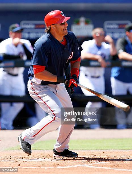 Mike Morse of the Washington Nationals follows his two-run home run in the 1st inning against the New York Mets at Tradition Field on March 7, 2010...