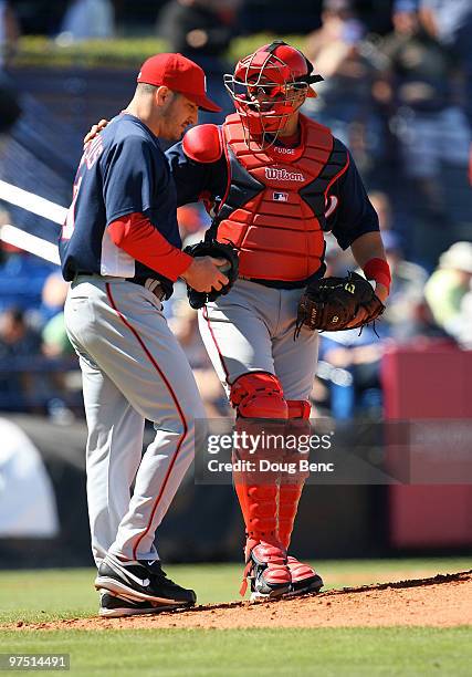 Catcher Ivan Rodriguez of the Washington Nationals talks with starting pitcher Jason Marquis in the 2nd inning against the New York Mets at Tradition...