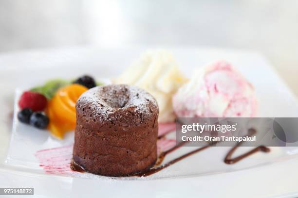 chocolate lava cake with ice cream and fruit - ice cream cake stock pictures, royalty-free photos & images