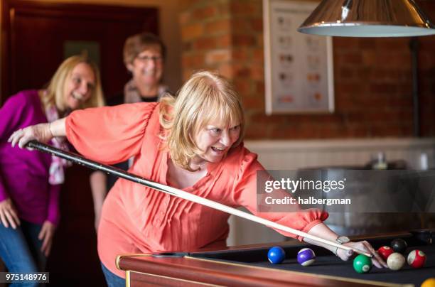 cheerful women playing pool - playing pool stock pictures, royalty-free photos & images