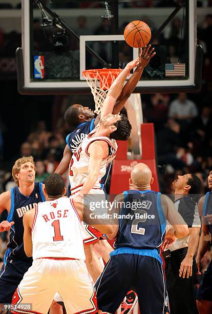 Kirk Hinrich of the Chicago Bulls goes up for the jump ball with Rodrique Beaubois of the Dallas Mavericks during the NBA game on March 06, 2010 at...