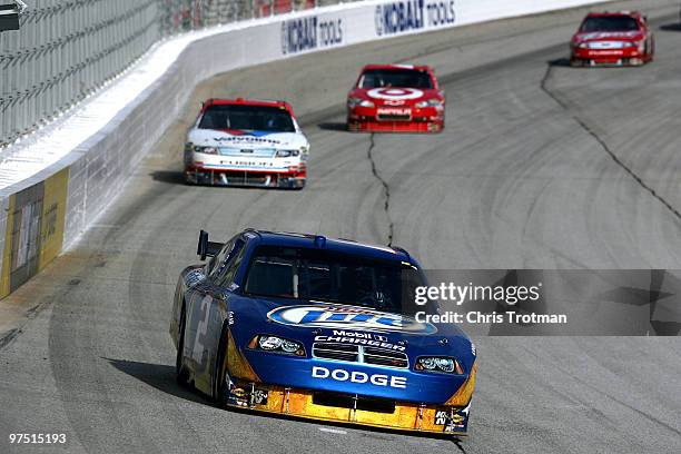 Kurt Busch, driver of the Miller Lite Dodge, leads Matt Kenseth, driver of the Valvoline Ford, Juan Pablo Montoya, driver of the Target Chevrolet,...