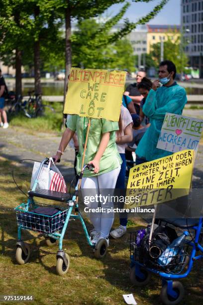 May 2018, Berlin, Germany: Participants have attached a sign that says "Altenpflege(lit. Elderly Care - We Care a lot" to a rollator at a...