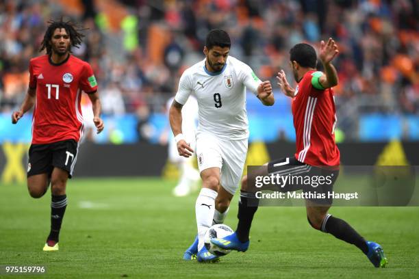 Luis Suarez of Uruguay is tackled by Ahmed Fathi of Egypt during the 2018 FIFA World Cup Russia group A match between Egypt and Uruguay at...