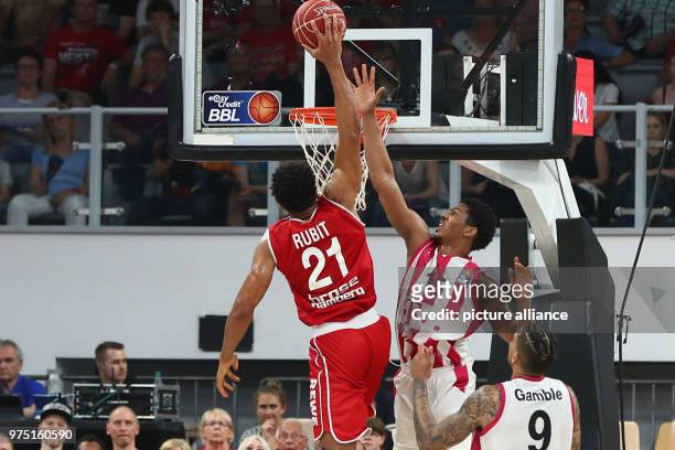 May 2018, Germany, Bamberg: Basketball, Bundesliga, Brose Bamberg vs Telekom Baskets Bonn. Bamberg's Augustine Rubit and Bonn's Malcolm Hill and...