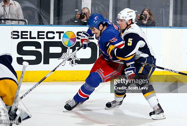 Brian Boyle of the New York Rangers skates for the puck against Toni Lydman of the Buffalo Sabres on March 7, 2010 at Madison Square Garden in New...