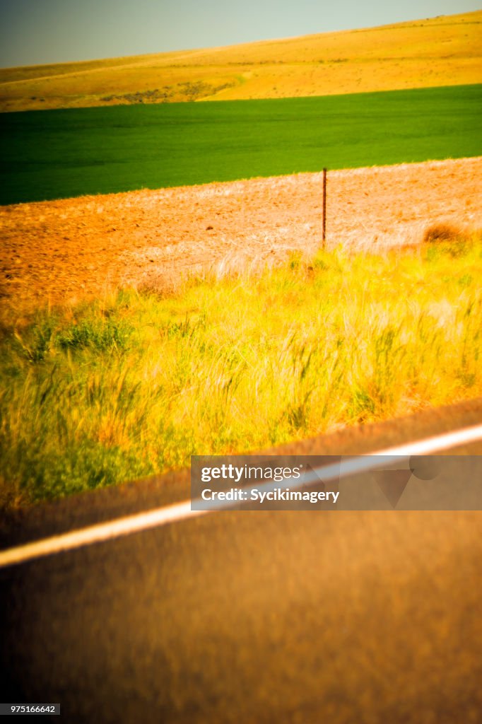 Rural field and hillside along highway