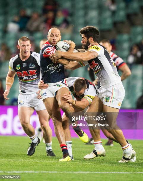 Blake Ferguson of the Roosters is tackled by James Tamou of the Panthers during the round 15 NRL match between the Sydney Roosters and the Penrith...