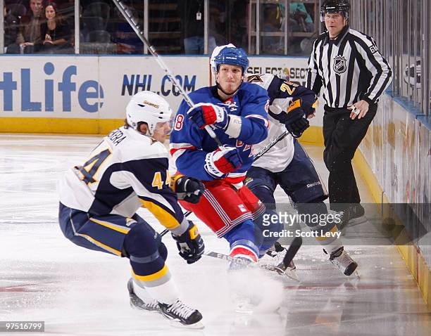 Marc Staal of the New York Rangers skates against Andrej Sekera and Michael Grier of the Buffalo Sabres on March 7, 2010 at Madison Square Garden in...