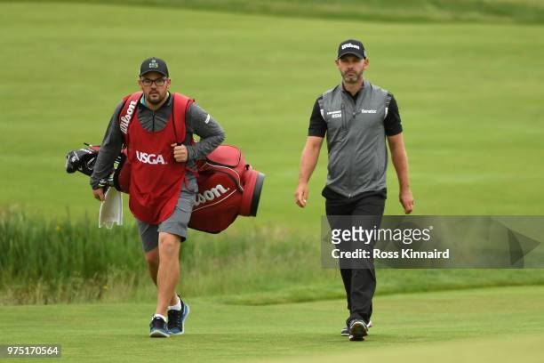 Paul Waring of England and his caddie walk on the 6th green during the second round of the 2018 U.S. Open at Shinnecock Hills Golf Club on June 15,...