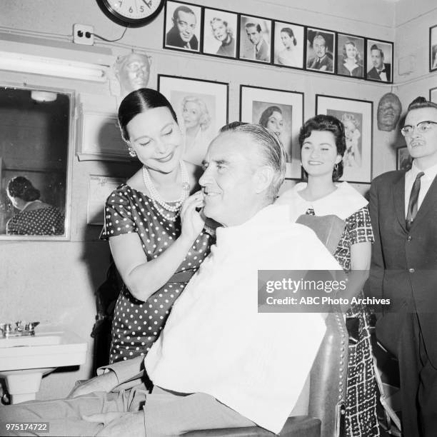 Ruth Hagy applying make-up to Governor of New York W Averell Harriman.