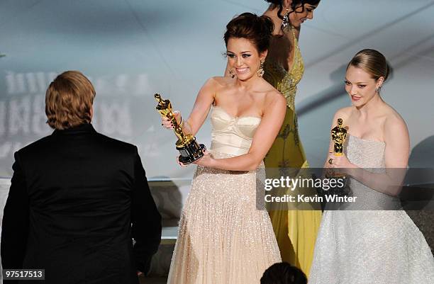 Musician T Bone Burnett walks onstage to accept Best Song award for "The Weary Kind" from presenters Miley Cyrus and Amanda Seyfried during the 82nd...