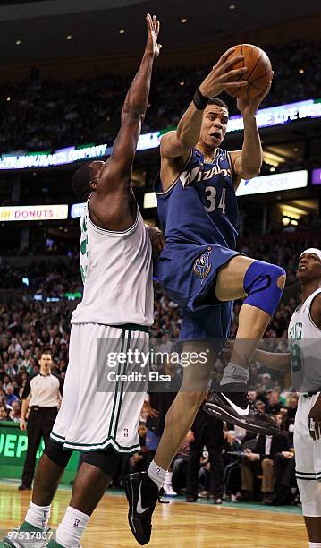 JaVale McGee of the Washington Wizards heads for the basket as Kendrick Perkins of the Boston Celtics defends on March 7, 2010 at the TD Garden in...