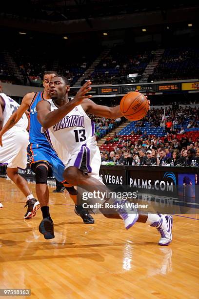 Tyreke Evans of the Sacramento Kings drives to the basket past Thabo Sefolosha of the Oklahoma City Thunder on March 7, 2010 at ARCO Arena in...