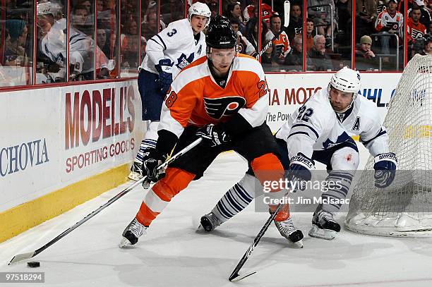 Francois Beauchemin of the Toronto Maple Leafs defends against Claude Giroux of the Philadelphia Flyers on March 7, 2010 at Wachovia Center in...