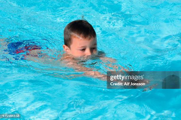 boy, seven years old, in a swimming school's pool, ystad, sweden - boys only caucasian ethnicity 6 7 years stock pictures, royalty-free photos & images