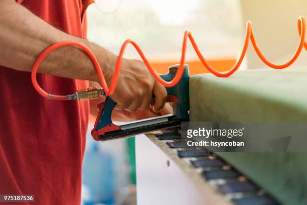 close-up of a man at work how upholstering furniture - upholstered furniture stock pictures, royalty-free photos & images