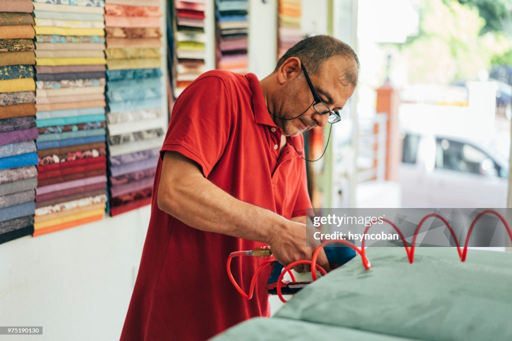 Factory Worker Upholstering Furniture Construction