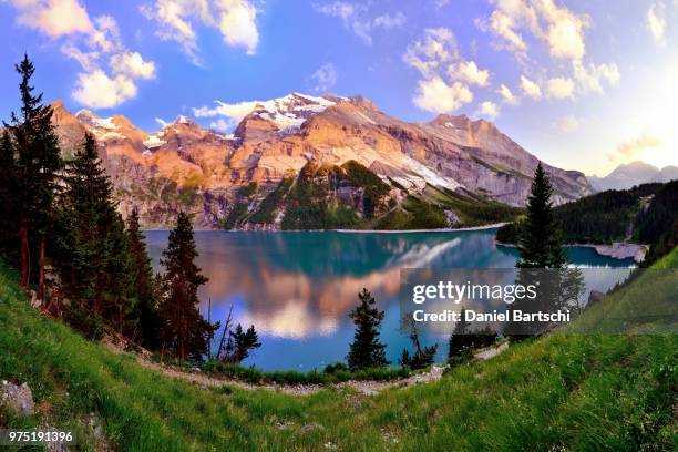 mountains in the evening light at the oeschinensee lake, unesco world heritage site, kandersteg, canton of bern, switzerland - kandersteg stock pictures, royalty-free photos & images