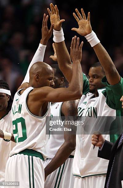 Ray Allen of the Boston Celtics is congratulated by teammates Tony Allen and Sheldon Williams after Allen shot the game winning three pointer with 17...