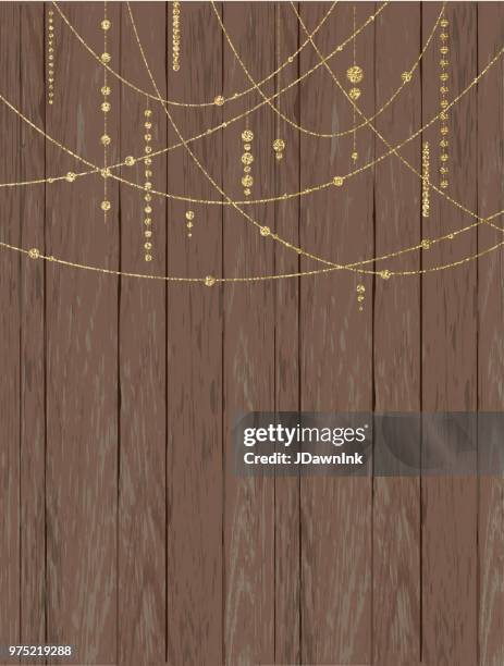rustic wooden background with glittering beads and strings - gold string stock illustrations